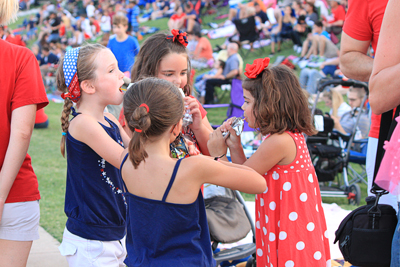 Girls eating candy at community event